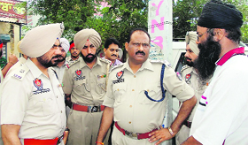 Police officers inquire about the murder in Khanna on Sunday.