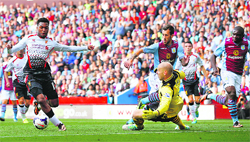 Liverpools Daniel Sturridge goes around Aston Villas Brad Guzan to score during their English Premier League match at Villa Park in Birmingham on Saturday