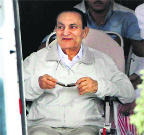 Former Egyptian President Hosni Mubarak being escorted into an ambulance to the Cairo Police Academy-turned-court in Cairo on Sunday. Mubarak is standing retrial on charges of complicity in the killings of protesters during the 2011 Egyptian uprising. The judge set the next session for September 14
