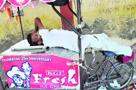 An ice-cream seller takes a nap near Government Rajindra College on a hot and humid Monday.