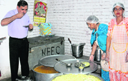 Senior UT official Mahavir Kaushik inspects the mid-day meal at Government Model School, Mani Majra. A Tribune Photograph 
