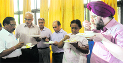 DPI (S) Upkar Singh (right) and other officials taste the mid-day meal at the inauguration of a kitchen at the GMSSS, Sector 15, Chandigarh, on Monday. Tribune Photo: Pradeep Tewari