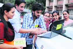 SOPU workers watch videos of their party on YouTube at Panjab University on Monday. Tribune Photo: Pradeep Tewari
