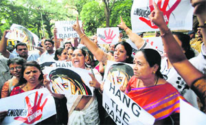 Protesters raise slogans during a demonstration against the rape of a photojournalist by five men inside an abandoned textile mill, in Mumbai on August 23. The attack triggered protests and an outcry on social media, with many people shocked that it took place in Mumbai, widely considered as a safe city for women. 