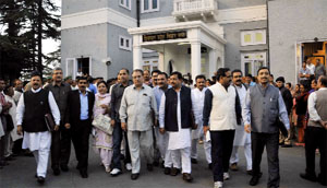 BJP legislatures walk out of the Vidhan Sabha in Shimla on Monday.