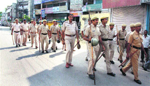 The police stages a flag march in Sadar Bazaar, Gurgaon, to maintain law and order during a bandh in protest against a youths murder at Jamalpur on Monday. 