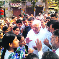 Haryana minister Satpal Sangwan tries to pacify agitated college girls Birhi Kalan village on Monday