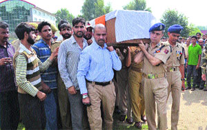 IGP, Kashmir range, Abdul Gani Mir carries the coffin of SOG personnel Salamat-ullah Khan at the Bijbehara police headquarters on Monday. Salamat-ullah was killed by militants in Arwani town near Bijbahara in Anantnag district. 