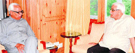 Governor N N Vohra interacts with MLC Vijay Bakaya at Raj Bhawan in Srinagar on Monday.