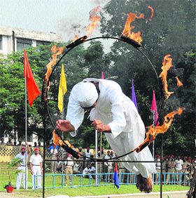  A Punjab Police jawan jumps through a ring of fire during the passing-out parade in Jalandhar on Monday. 