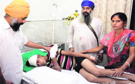 A boy, who got electrocuted from high-tension wires and got injured at Guru Nanakpura, being treated at PIMS in Jalandhar on Monday.