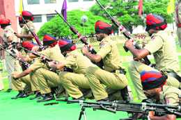 Blindfolded Punjab police jawans aim at targets during the passing out parade at PAP Grounds in Jalandhar on Monday. 