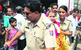 A minor girl who, was being married off, being taken away after the police stopped the marriage in Jalandhar on Sunday.