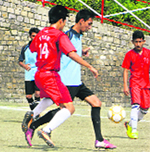 Players vie for the ball during a match of the 16th All India Bhupinder Singh Memorial soccer tournament in Sanawar on Monday.