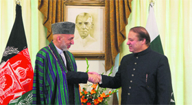 Afghan President Hamid Karzai (R) shakes hands with Pakistan Prime Minister Nawaz Sharif in Islamabad on Monday.