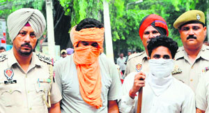 the two smugglers in police custody in Amritsar on Tuesday.