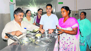 Employees serve free food to patients at Guru Nanak Dev Hospital in Amritsar on Tuesday. 