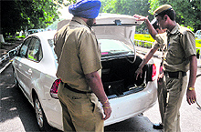 Police personnel check a car at Gate No. 1 on the Panjab University campus on Tuesday