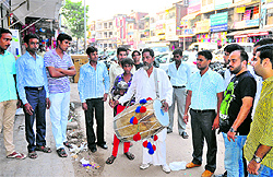 A munadiwala beats the dhol at Mani Majra on Tuesday