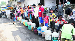 Residents wait in a queue for their turn to get water from a tanker at Sector 32, Chandigarh, on Tuesday