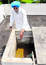Col Pritam Bhullar shows an empty overhead tank at his residence in Sector 2