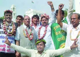 BJP leaders shout anti-Delhi Government slogans in protest against the hike in prices of onion during the first day of the Monsoon Session of the Delhi Assembly on Tuesday