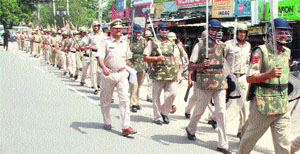 Police personnel conduct a flag march in Gurgaon on Tuesday.