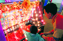 A child pulls the string of Lord Krishnas cradle as part of Janmashtami celebrations in Mussoorie on Wednesday