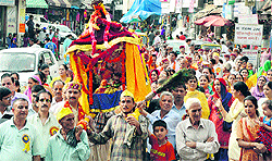 Devotees take part in a procession on the occasion of Janmashtami in Mandi on Wednesday