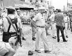 Police personnel at the spot after an IED exploded at Bongaigaon in Assam on Wednesday.  PTI