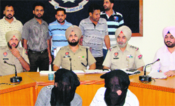 Accused SI Fakeer Chand and his accomplice in police custody. A Tribune photo 