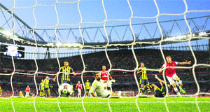 Arsenals Aaron Ramsey (extreme right) scores against Fenerbahce during their Champions League playoff match at the Emirates Stadium in London on Tuesday. 
