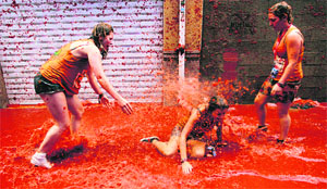 Revellers play in tomato pulp during the annual Tomatina festival in Valencia, Spain, on Wednesday.