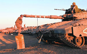 A soldier adjusts sights on a tank in the Israeli-occupied Golan Heights, Syria, on Wednesday.