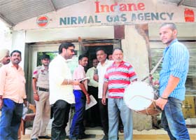A dholi beats a drum in front of a gas agency, which owns taxes to the MC, in Amritsar on Thursday