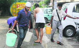 Residents fill their buckets from a water tanker In Phase X, Mohali, on Thursday.