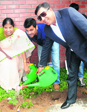 Cricketer RP Singh and golfer Harmeet Kahlon water a plant at New Public School in Chandigarh on Thursday.