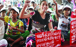 Children hold placards as they take part in a dharna, demanding the passing of 