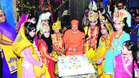 Devotees cut a cake at midnight as part of celebrations of the birth of Lord Krishna at Siddh Ashram in Haridwar on Thursday. Tribune photo: Rameshwar Gaur