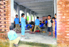 In the absence of books, students while away their time in Government Middle School at Mithapur village in Ambala.