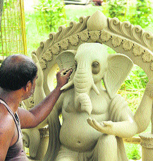 An artist prepares a statue of Lord Ganesha in Jalandhar on Thursday in view of the upcoming festival season.