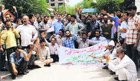 Members of the Urban Local Bodies Employees United Forum protest in Srinagar on Thursday.