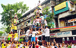Revellers form human pyramids to break the dahi-handi on Janmashtami in Mumbai on Thursday