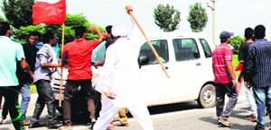 Protesters block the Amritsar-Jalandhar highway near Manawala in Amritsar on Thursday. 