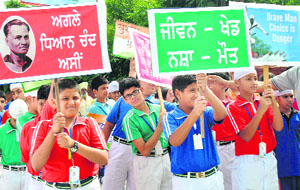 Students of a private school hold an awareness rally on the National Sports Day in Patiala on Thursday. 