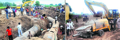 Repair work on the damaged water pipelines at Gharuan village near Kharar had to be halted after a machine (right), which was to be used for concrete work, got stuck in a quagmire while being taken to the site on Friday.