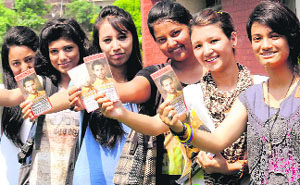 PUSU supporters hold pamphlets of their party leader while campaigning at the UIET at Panjab University.