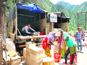 Save the Children volunteers distribute relief material in disaster-affected areas. 