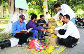 Students of the College of Agricultural Engineering and Technology work as fruit vendors outside HAU in Hisar on Friday to press their demands for including B Tech( Agriculture Engineering) as a qualification for posts of agriculture development officer and creating a separare directorate of agriculture engineering.