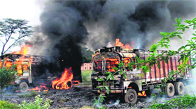 Trucks torched by irate villagers in Gurgaon.